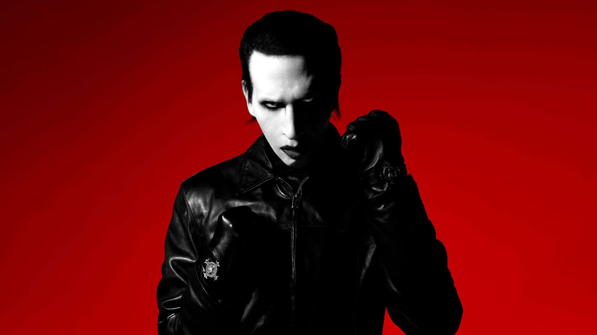 Schockrocker Marilyn Manson auf einem aktuellen Pressefoto aus dem Jahr 2024, in Schwarz gekleidet und die Hände zu Fäusten geballt wie bei einem Boxkampf